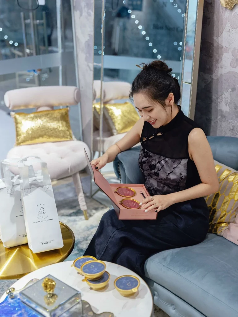 A lady opens a birds nest capsule in the store.